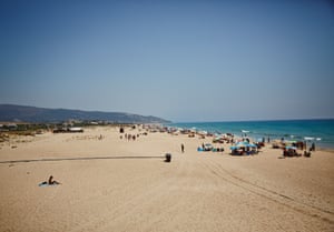 Spanish officials bleaching the beach!